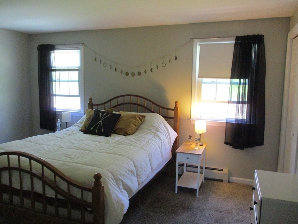 2 Tuck Farm Road, Unit 5 Auburn, MA 01501 - Photo 8 of 11 a bedroom with a bed and a tv on table