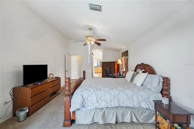 a bedroom with a bed and flat screen tv