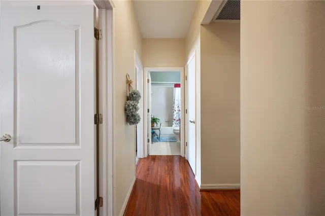 a view of a hallway with wooden floor and entryway