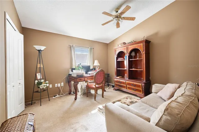 a living room with furniture a rug and a chandelier