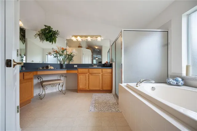 a bathroom with a bathtub sink and mirror
