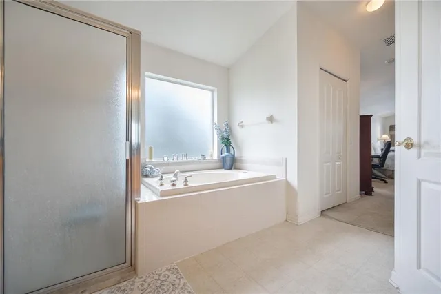 a bathroom with a tub sink and mirror