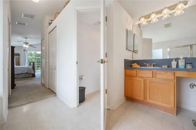 a en suite bathroom with a granite countertop sink mirror and shower
