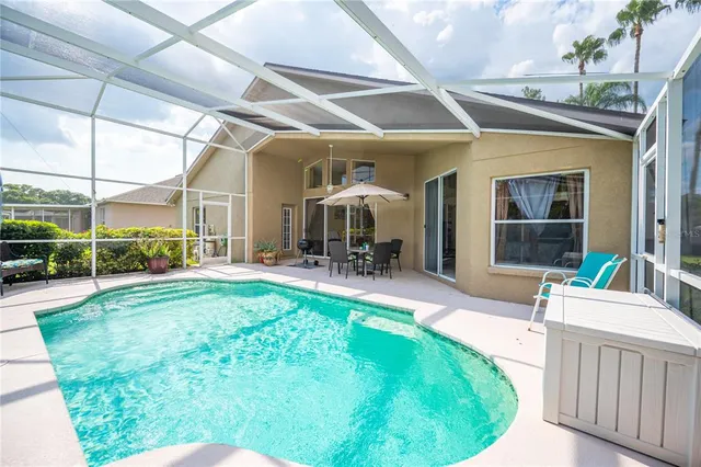 a view of a house with backyard porch and sitting area