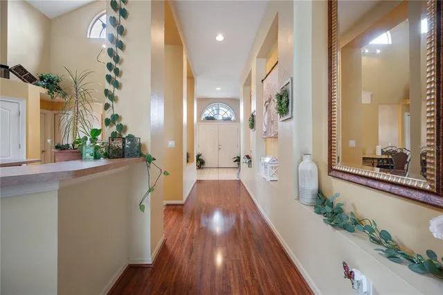 a view of a hallway with wooden floor and stairs