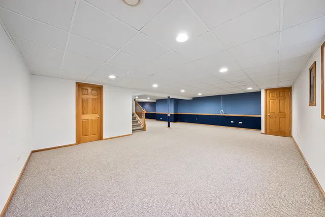 a view of empty room with a kitchen