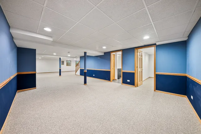 a view of an empty room with closet and a couch