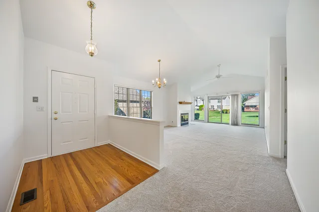 a view of a room with a window and wooden floor