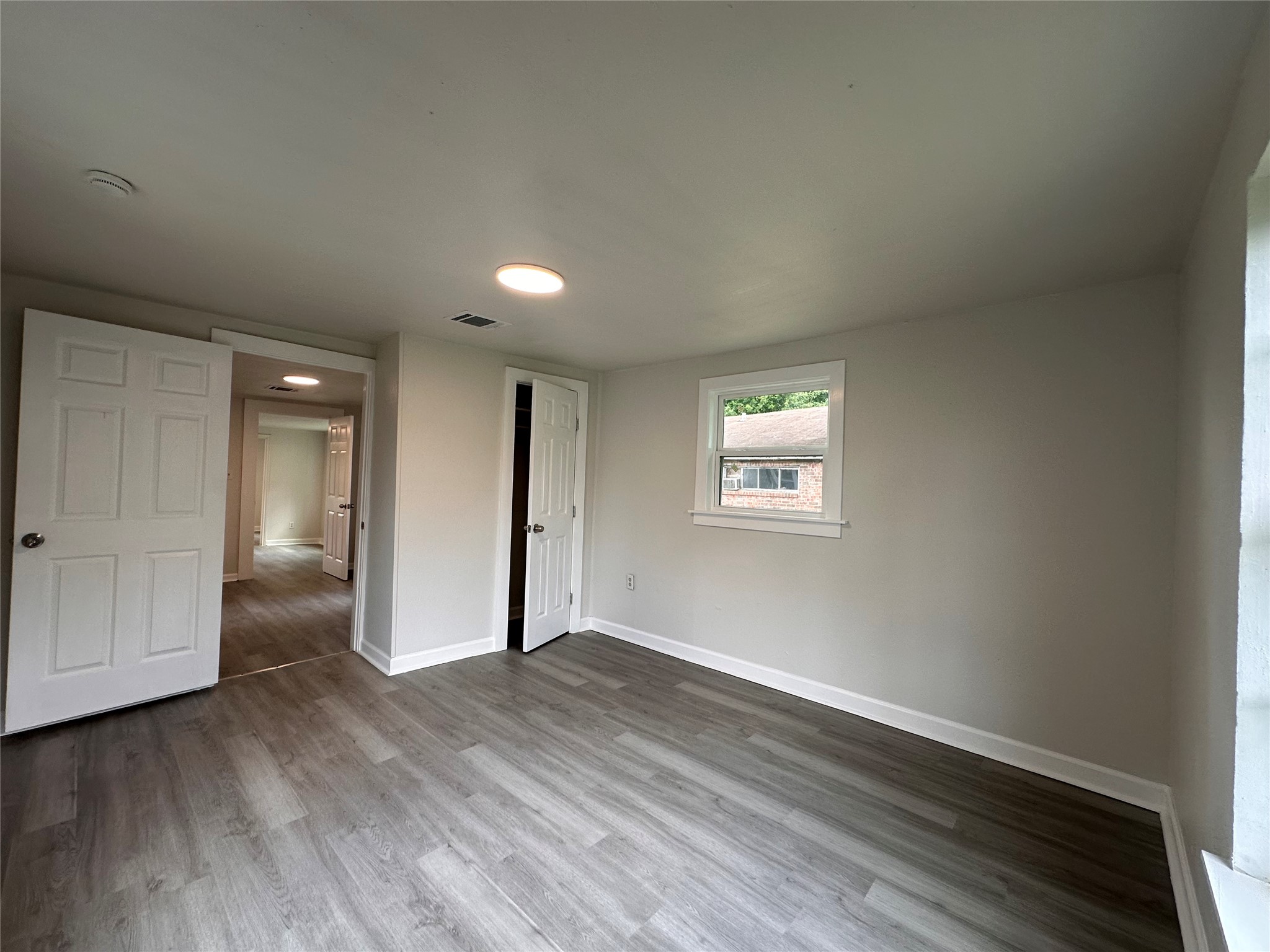 2516 Ivy Street Houston, TX 77026 - Photo 6 of 9 a view of an empty room with wooden floor and closet
