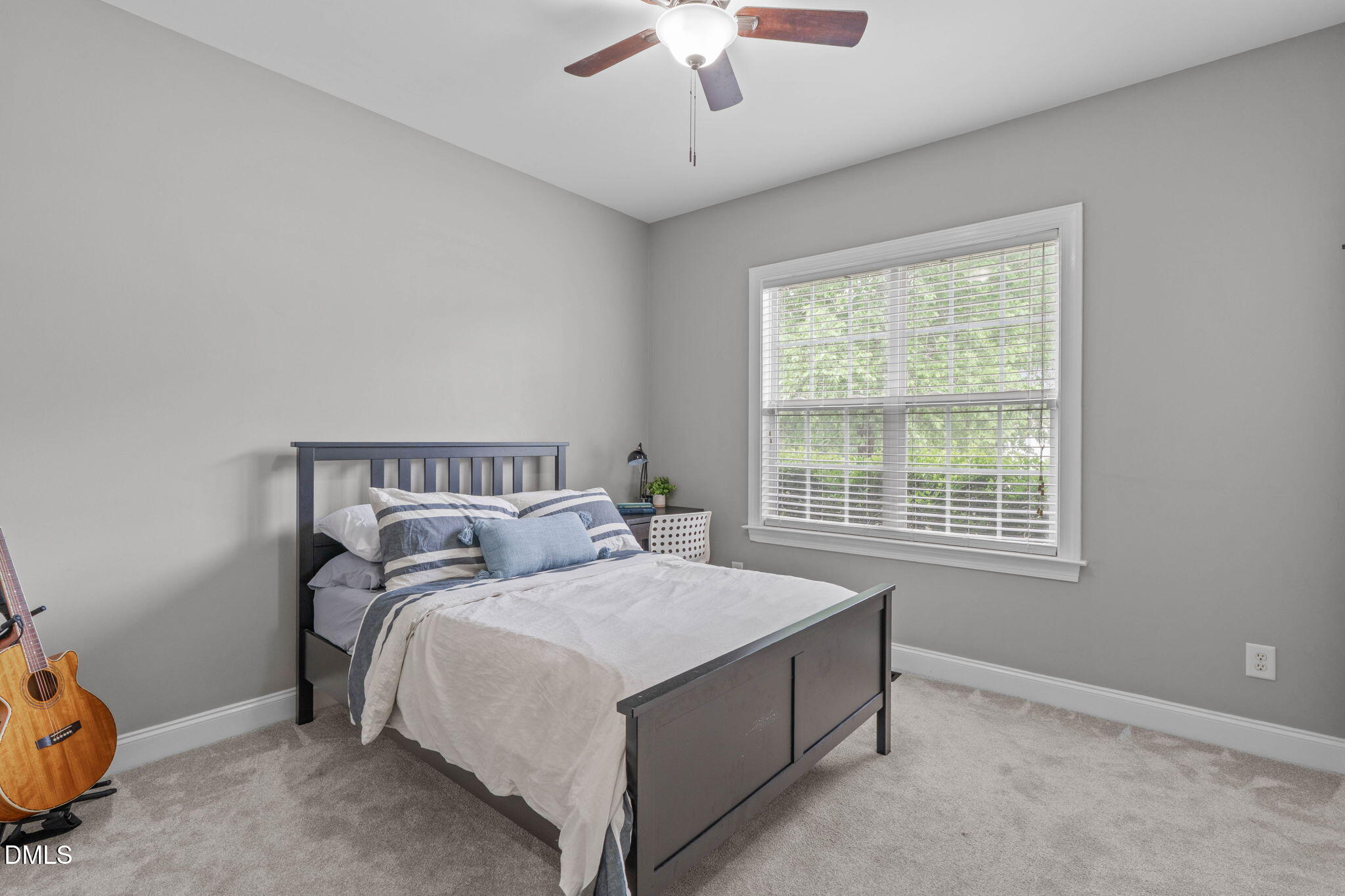 2450 Rolling Tracks Road Willow Spring, NC 27592 - Photo 34 of 64 a bed sitting in a bedroom next to a window