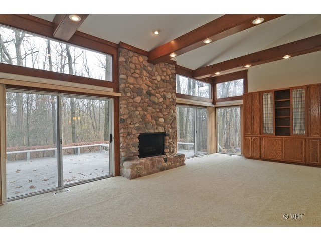 721 Rockefeller Road Lake Forest, IL 60045 - Photo 6 of 10 a living room with furniture tv and a fireplace