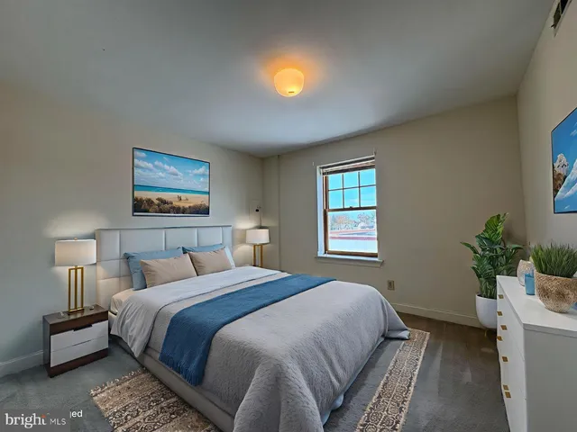 a bedroom with a bed and a potted plant