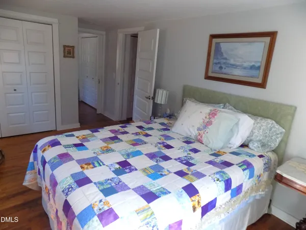 a bedroom with a bed and a lamp