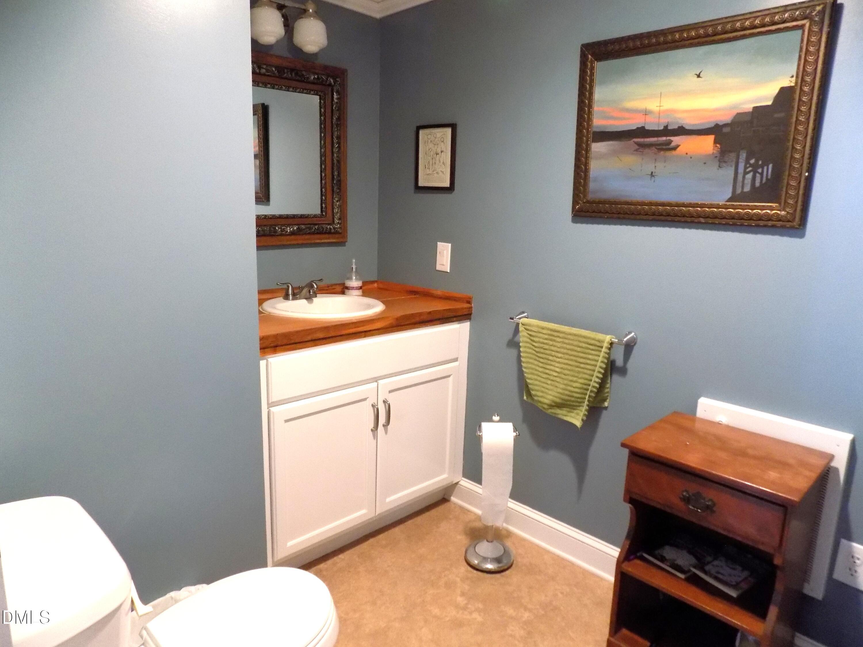 15 Full Circle Spring Hope, NC 27882 - Photo 23 of 51 a bathroom with a toilet a sink and mirror