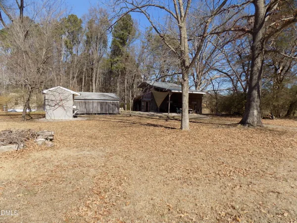 a view of a backyard with large trees
