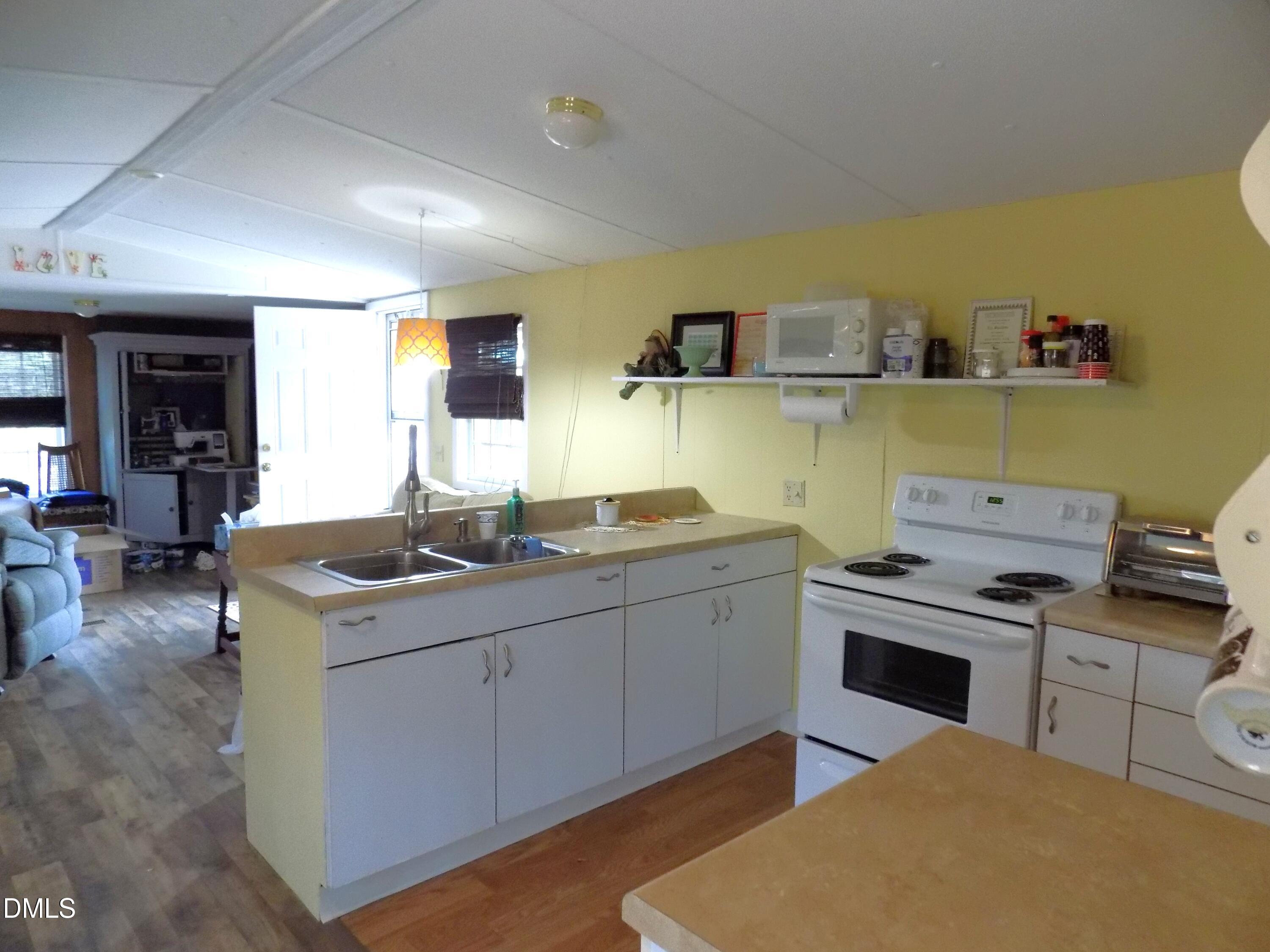 15 Full Circle Spring Hope, NC 27882 - Photo 31 of 51 a kitchen with stainless steel appliances granite countertop a sink and a stove