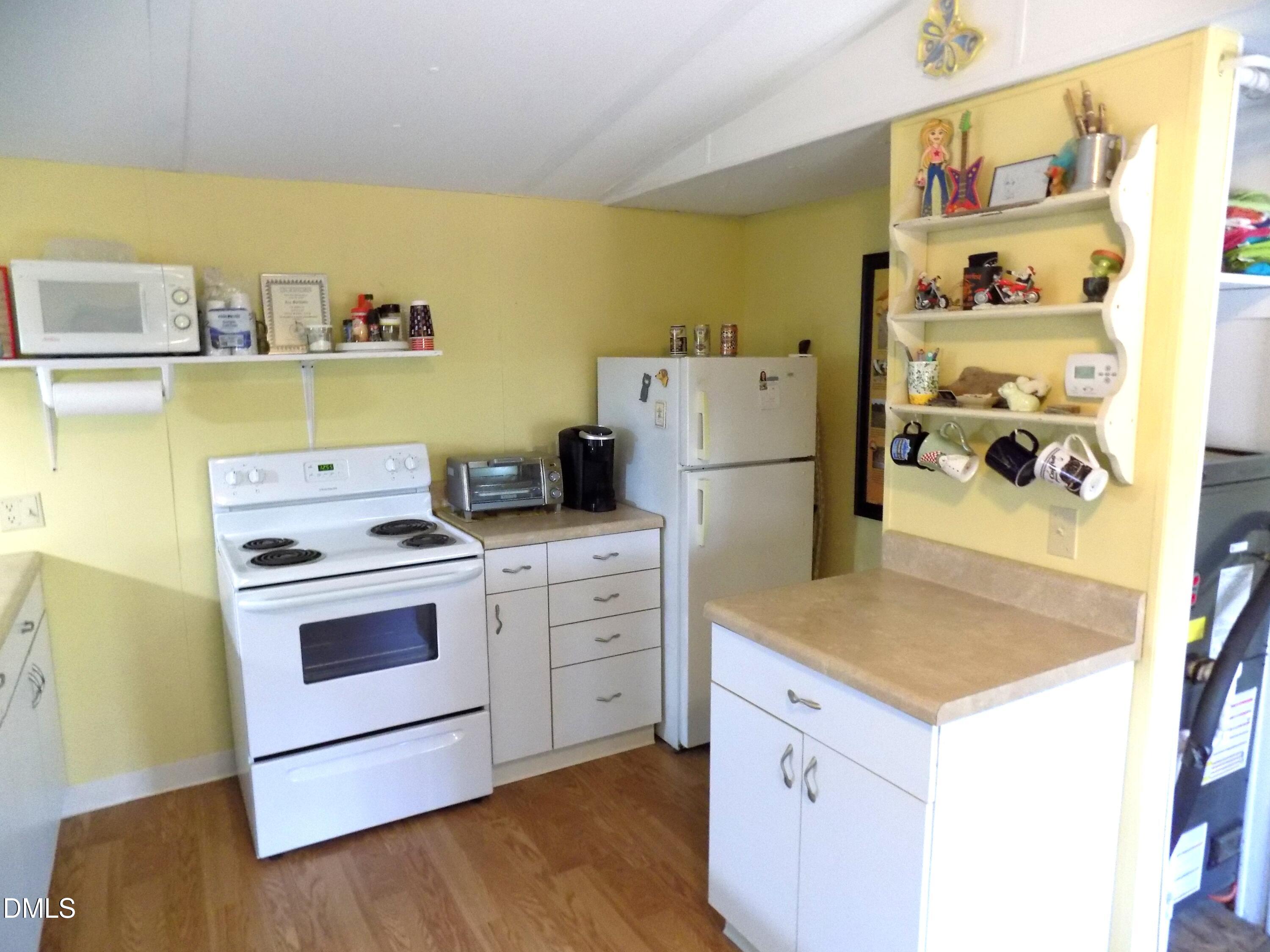 15 Full Circle Spring Hope, NC 27882 - Photo 32 of 51 a kitchen with a stove and a refrigerator