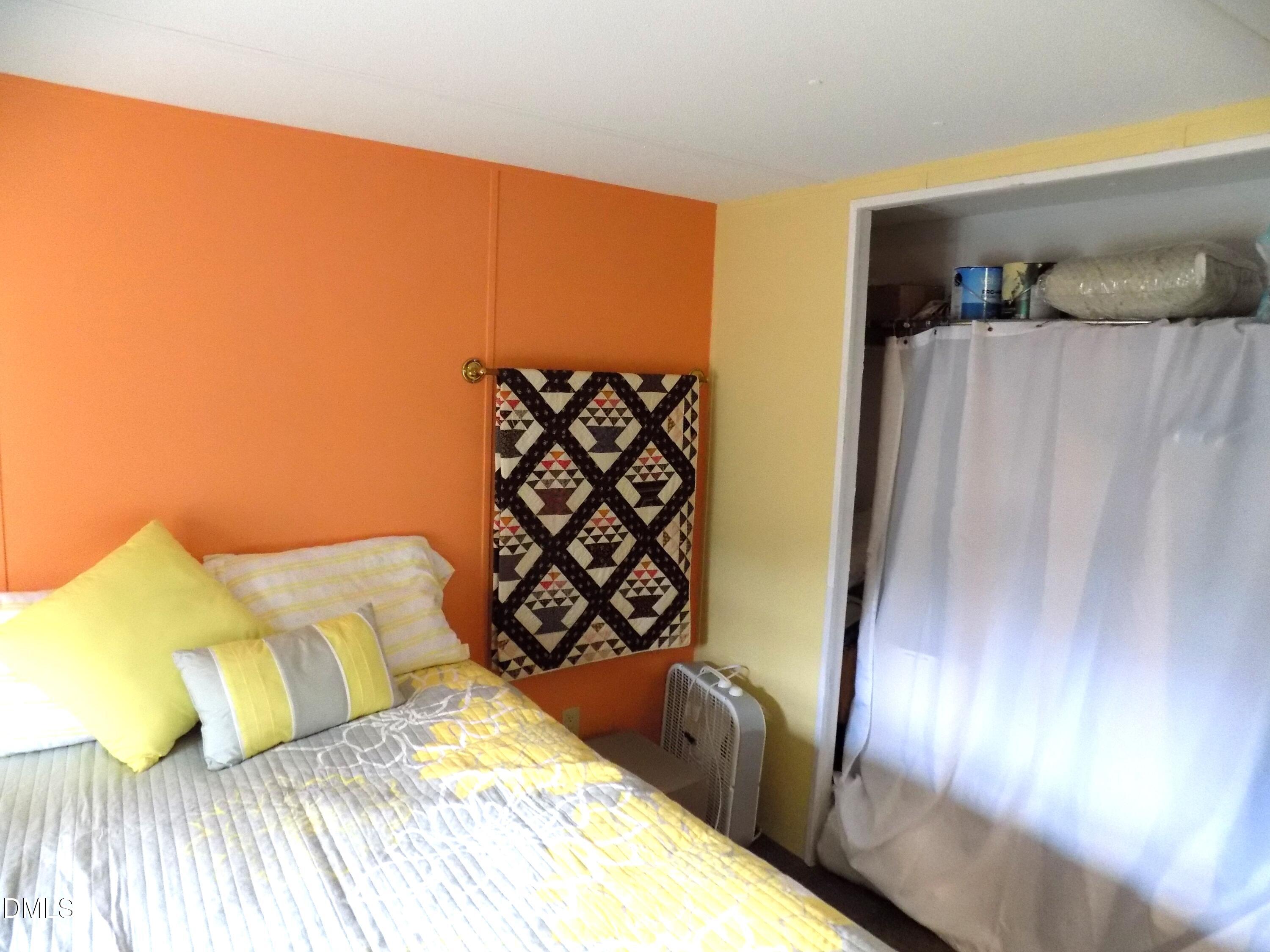 15 Full Circle Spring Hope, NC 27882 - Photo 39 of 51 a bedroom with a bed and a painting on the wall