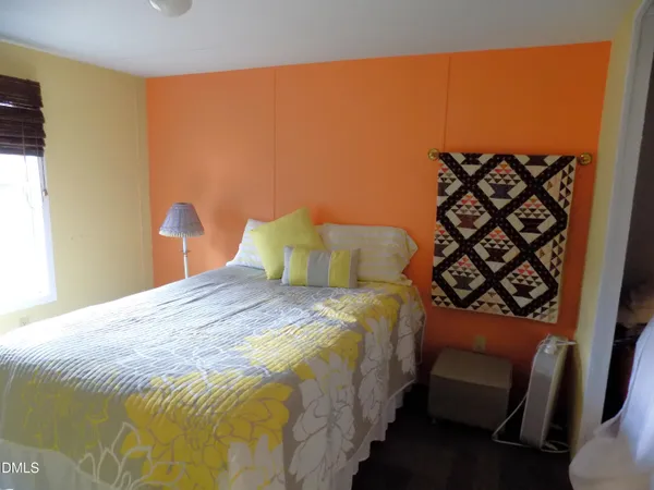 a bedroom with a bed and a chair