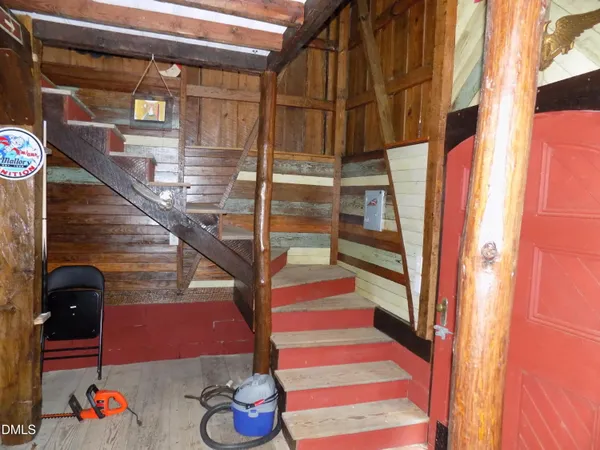 a living room with a couch and dresser with wooden floor