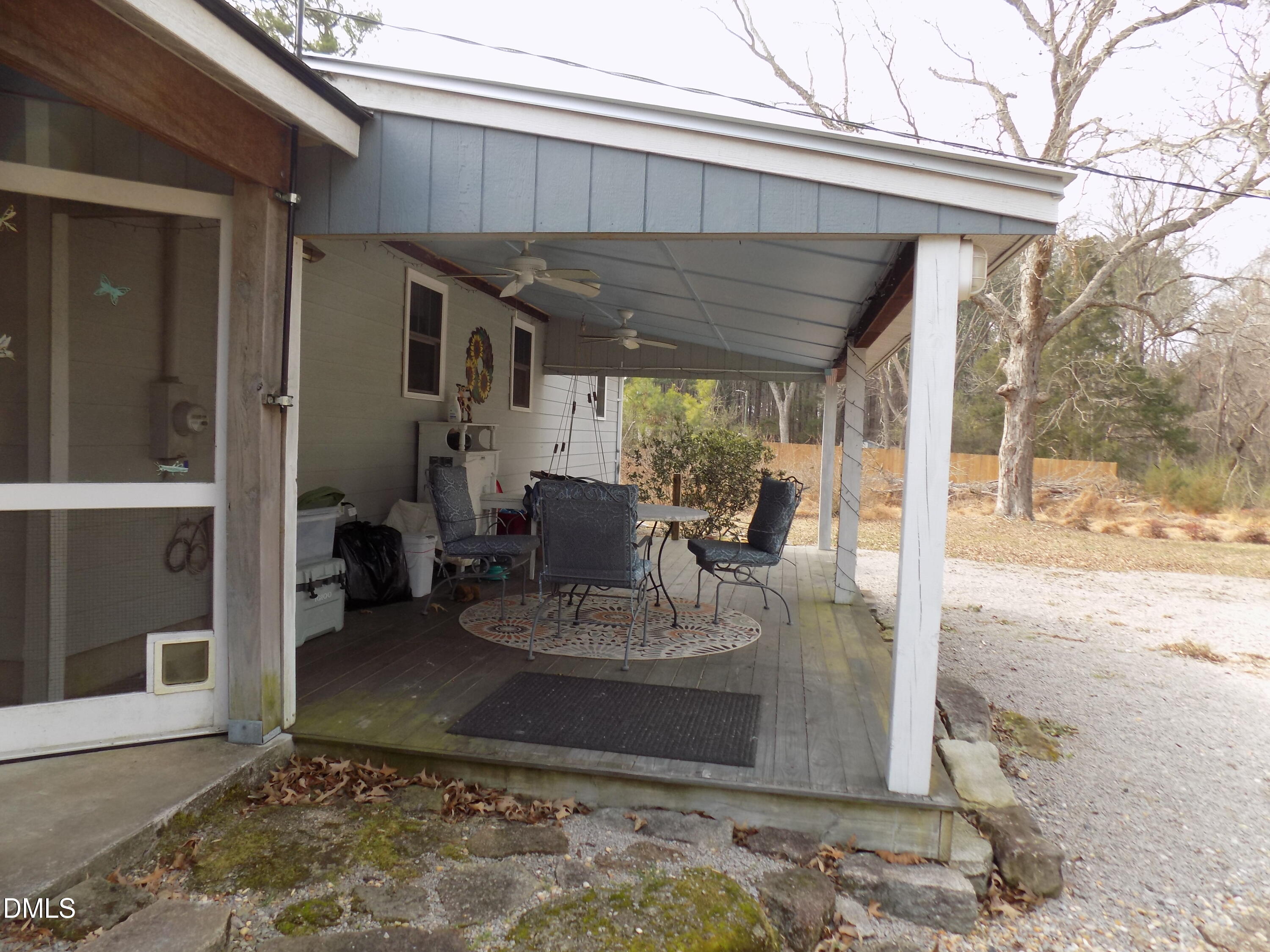 15 Full Circle Spring Hope, NC 27882 - Photo 7 of 51 a view of a patio with table and chairs potted plants and floor to ceiling window