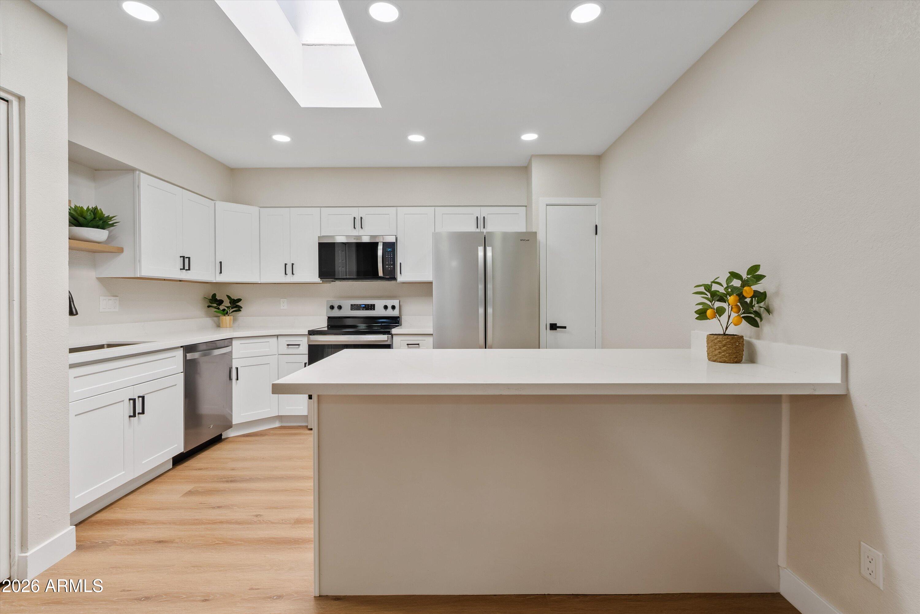 720 South Dobson Road, Unit 55 Mesa, AZ 85202 - Photo 9 of 33 a kitchen with granite countertop white cabinets and white appliances