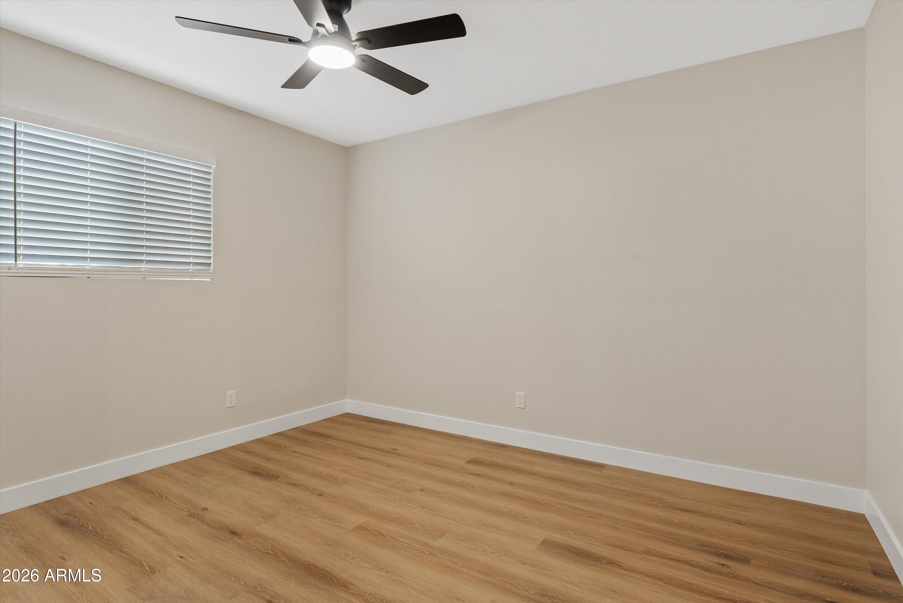 720 South Dobson Road, Unit 55 Mesa, AZ 85202 - Photo 15 of 33 wooden floor in an empty room with a window