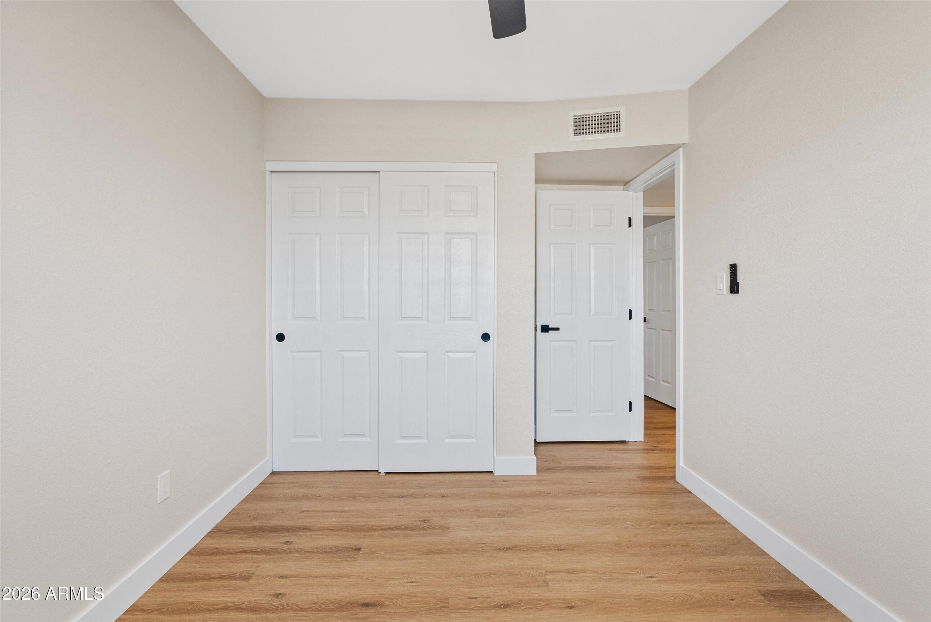 720 South Dobson Road, Unit 55 Mesa, AZ 85202 - Photo 19 of 33 a view of an empty room with wooden floor