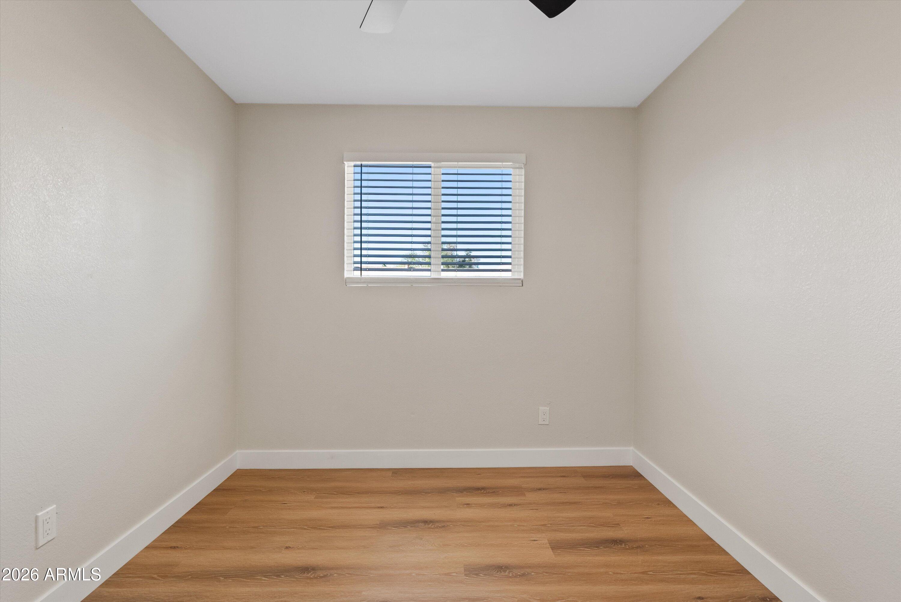 720 South Dobson Road, Unit 55 Mesa, AZ 85202 - Photo 20 of 33 a view of an empty room with wooden floor and a window