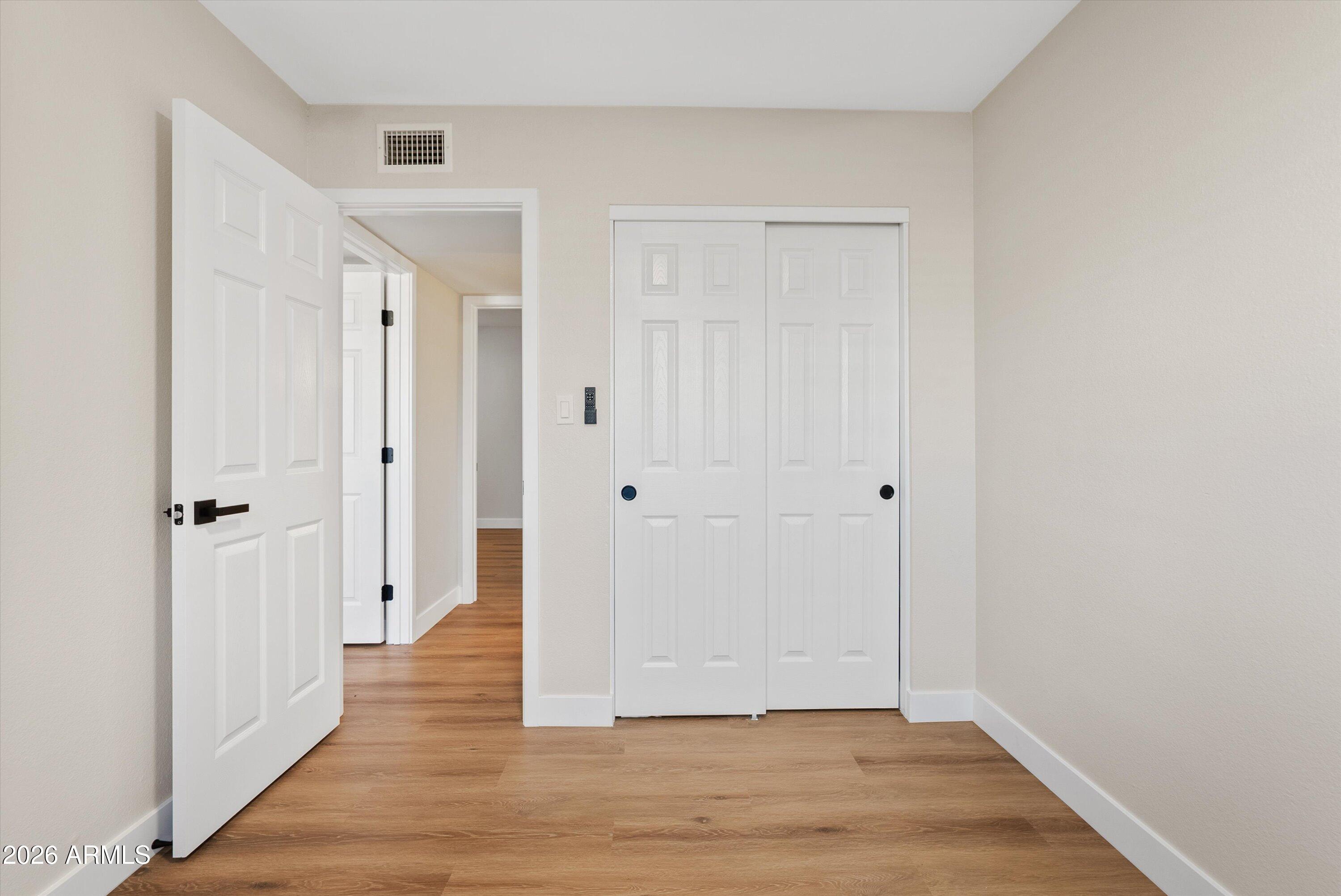 720 South Dobson Road, Unit 55 Mesa, AZ 85202 - Photo 21 of 33 a view of a hallway with wooden floor