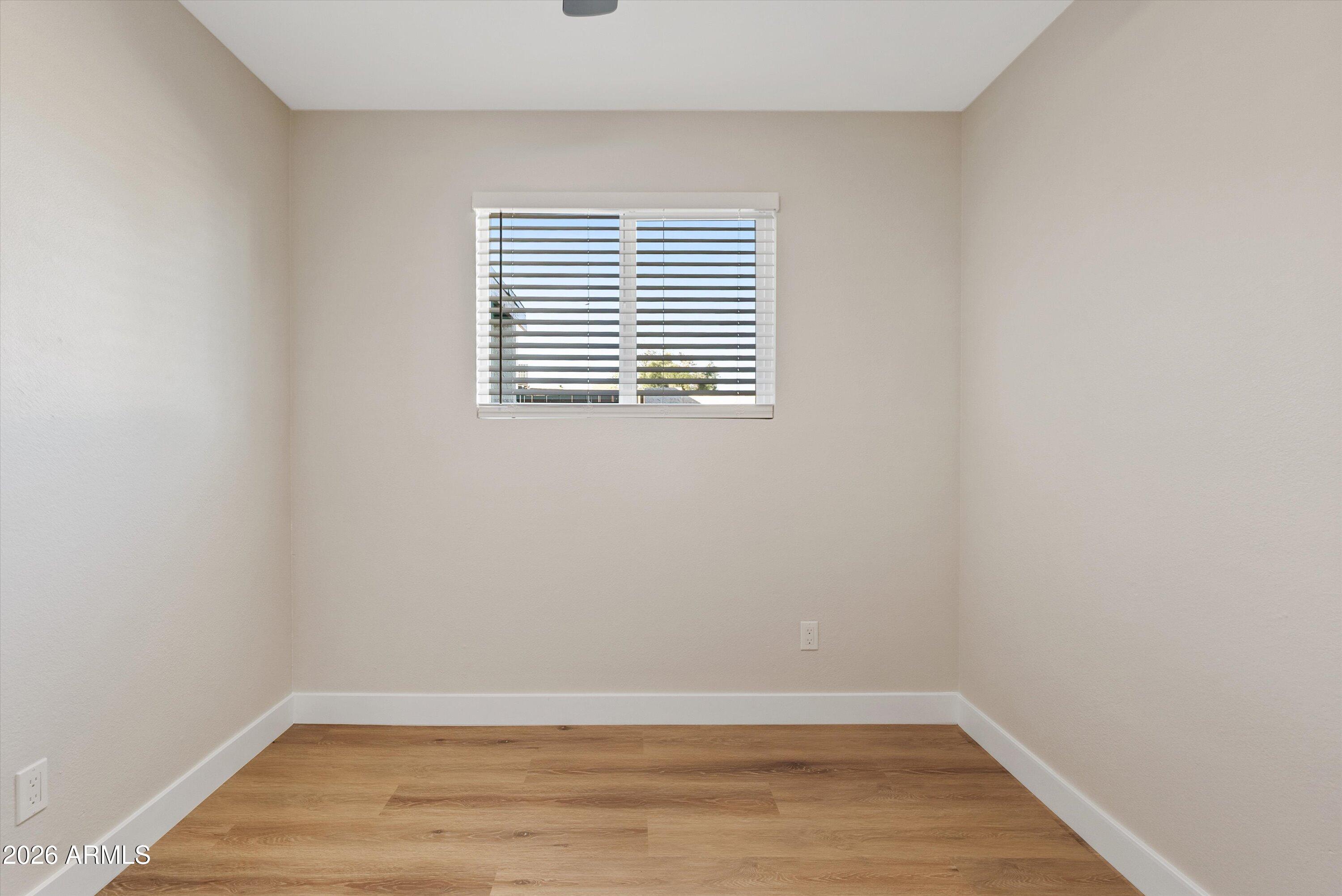 720 South Dobson Road, Unit 55 Mesa, AZ 85202 - Photo 22 of 33 a view of an empty room with wooden floor and a window