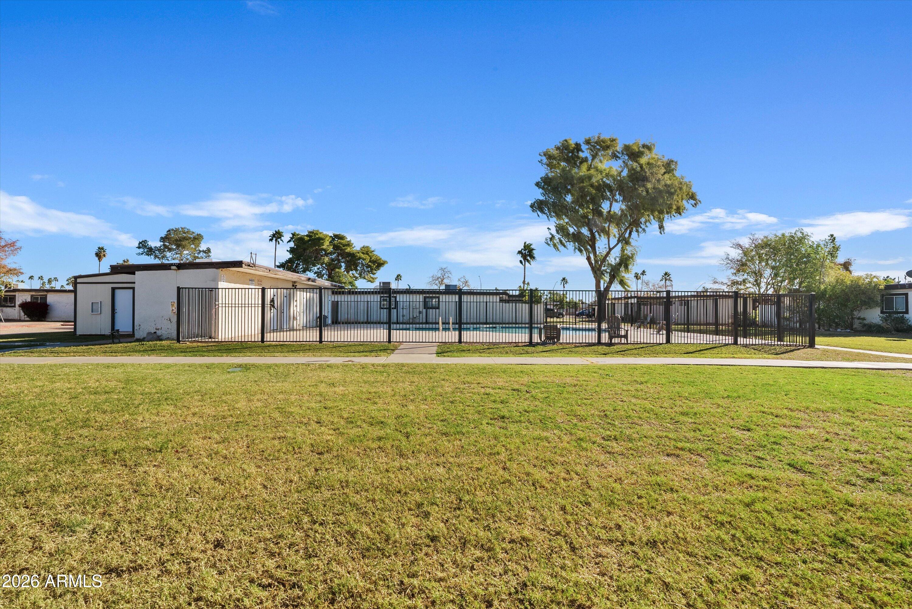 720 South Dobson Road, Unit 55 Mesa, AZ 85202 - Photo 29 of 33 a swimming pool with outdoor seating and yard