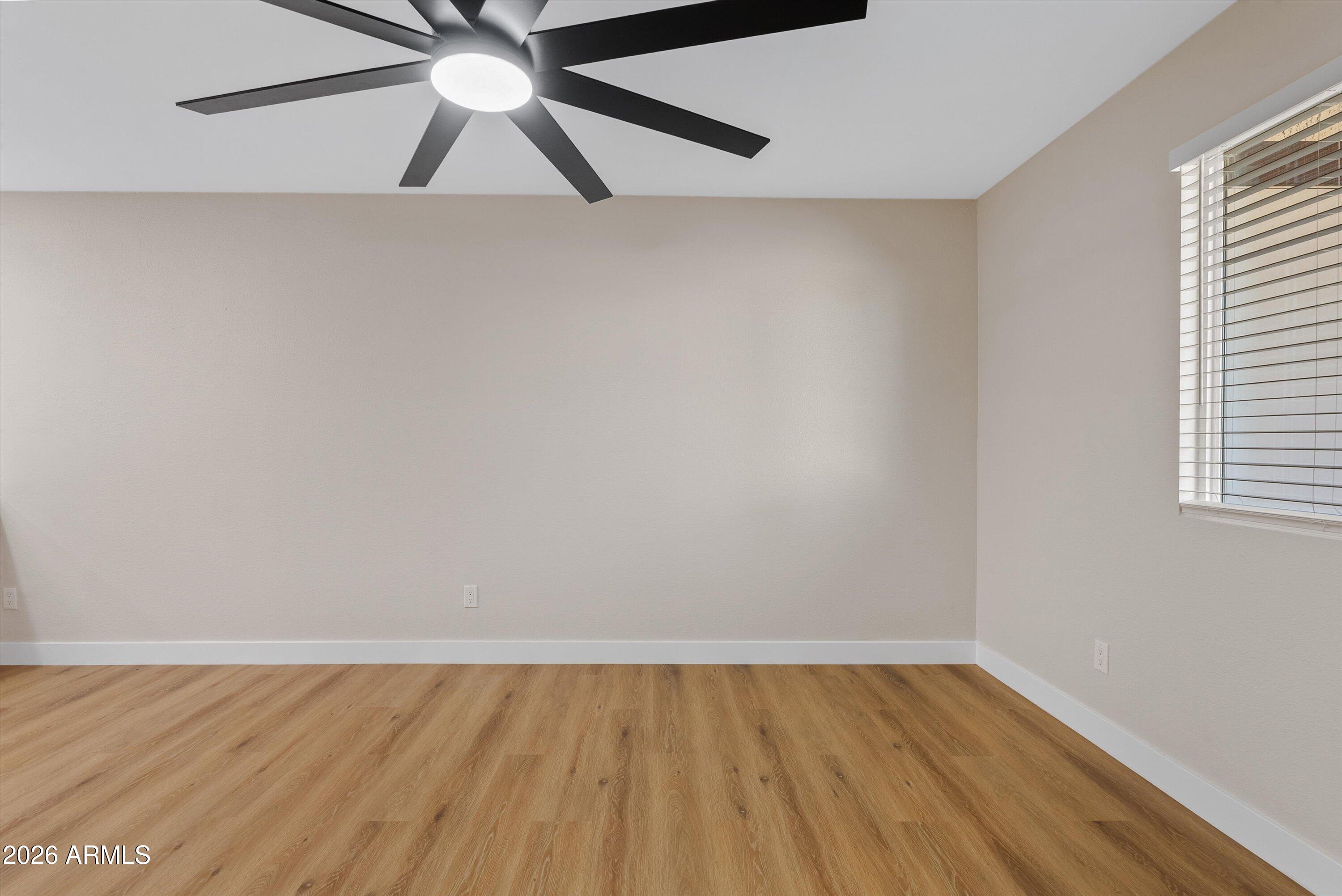 720 South Dobson Road, Unit 55 Mesa, AZ 85202 - Photo 8 of 33 a view of an empty room with wooden floor and a window
