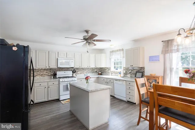 a kitchen with a sink stove and refrigerator