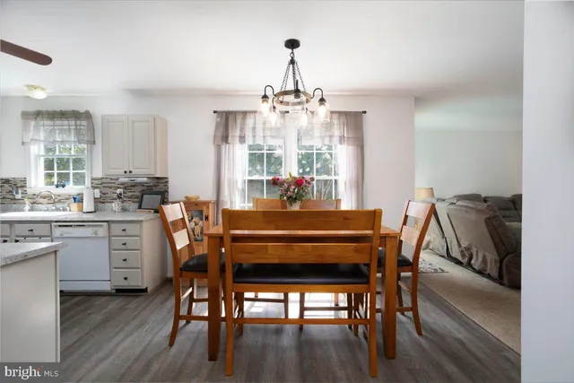 a dining room with furniture window and wooden floor