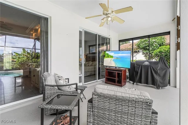 a living room with patio furniture and a fireplace