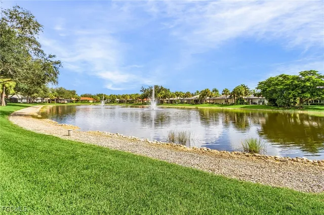 a view of a lake with houses in the back