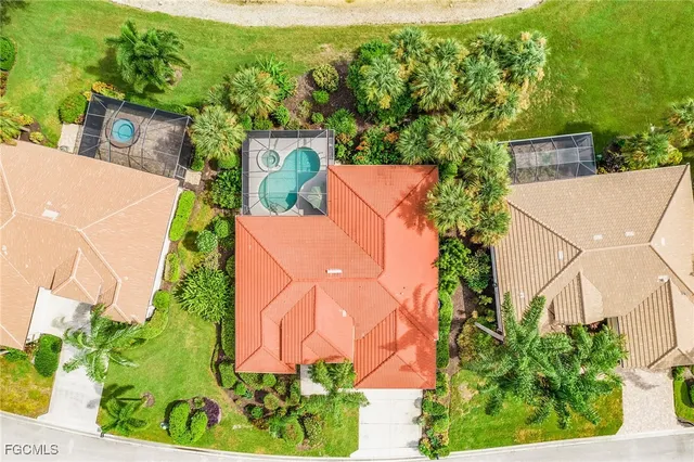 an aerial view of a house with a yard and outdoor seating