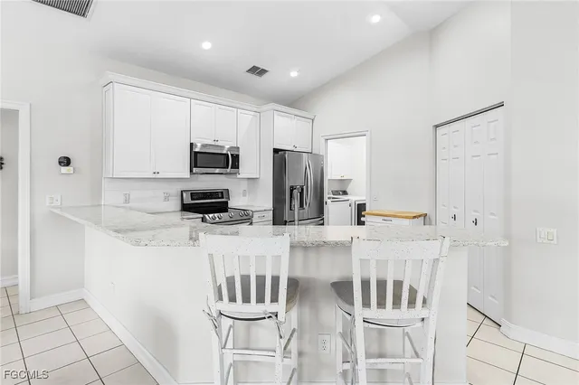 a kitchen with stainless steel appliances a refrigerator and a stove top oven