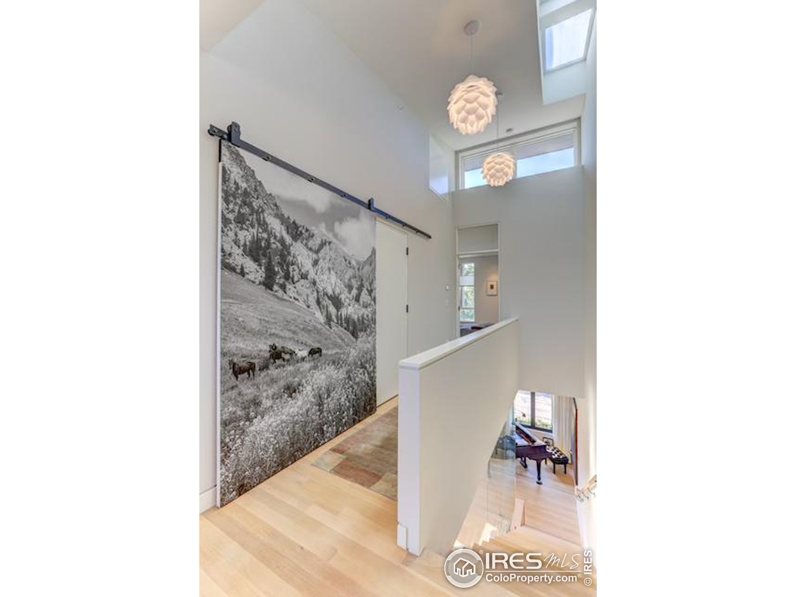 153 Mathews Street, Unit 113A Fort Collins, CO 80524 - Photo 12 of 29 a view of a hallway with paintings on the wall
