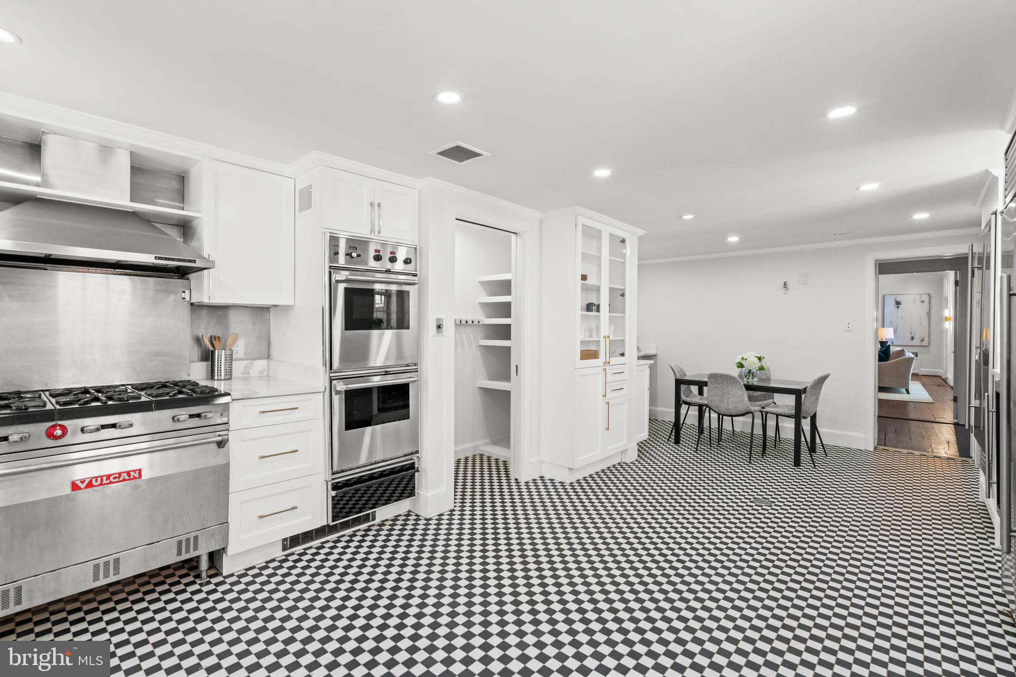1406 34th Street Northwest Washington, DC 20007 - Photo 20 of 45 a kitchen with stainless steel appliances a stove a refrigerator a table and chairs