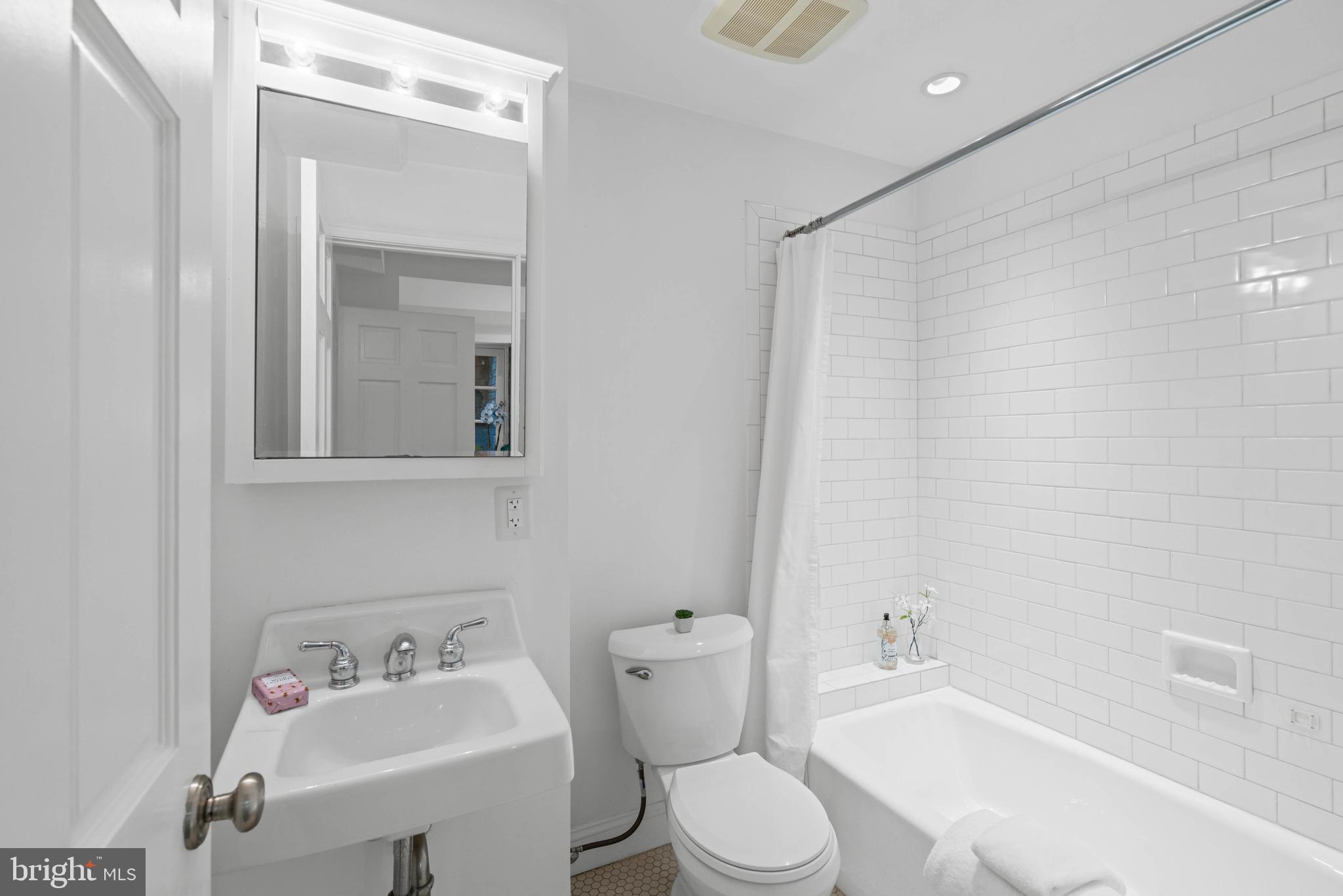 1406 34th Street Northwest Washington, DC 20007 - Photo 9 of 45 a bathroom with a sink toilet and shower