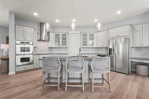 a large kitchen with a table and chairs