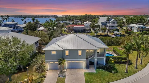 a aerial view of a house next to a yard