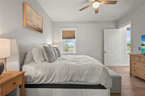 a bedroom with a bed and a painting on the wall