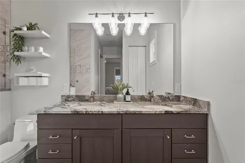 a kitchen with granite countertop white cabinets and a stove