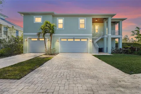 a front view of a house with a yard and a garage