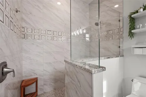 a outdoor space with the couches and a dining table with the potted plants