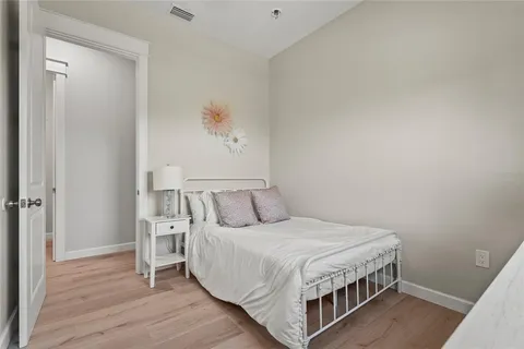 a view of a swimming pool with a yard and plants
