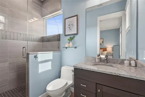 a living room with furniture and a ceiling fan